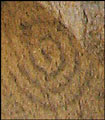 Neolithic sun sign on rock wall