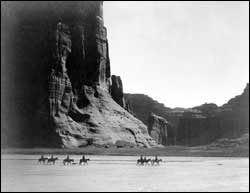 Old photo of Navajo people riding on their Nation