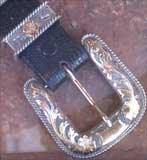 Leather belt with patterned silver buckle