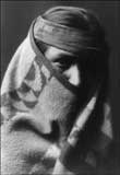 Old photo of a Navajo man wrapped in a warm blanket