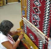 Navajo weaver creating a rug 